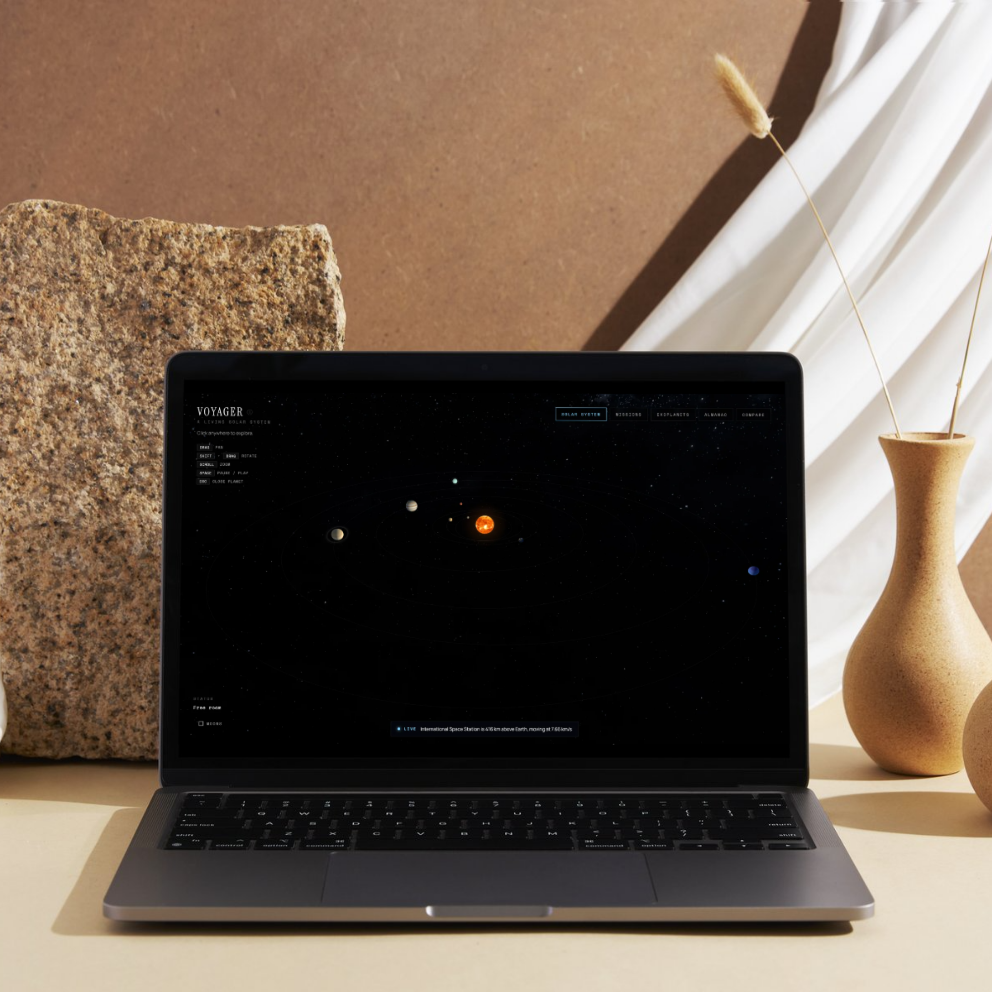 Voyager solar system view shown on a laptop in a styled product mockup